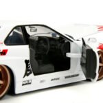 2002 Nissan Skyline GT-R (R34) RHD (Right Hand Drive) White with Red Graphics and Ryu Diecast Figure "Street Fighter" Video Game "Anime Hollywood Rides" Series 1/24 Diecast Model Car by Jada